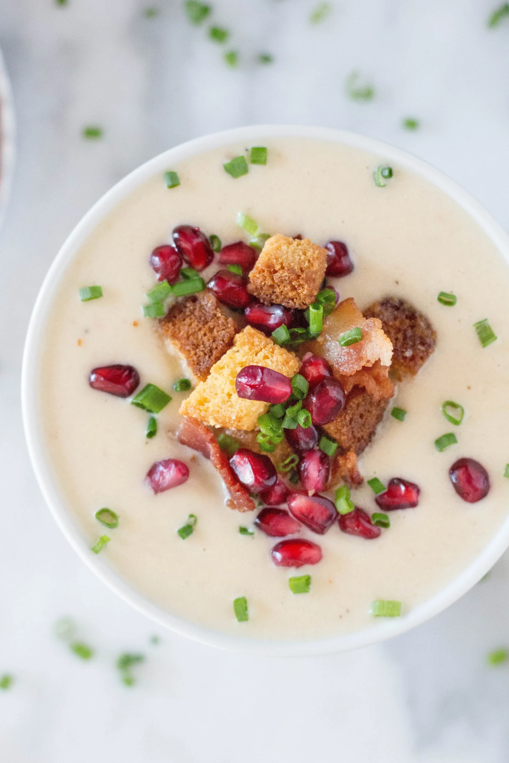 Creamy Parsnip Soup with Cornbread Croutons, Crispy Bacon, Pomegranate Arils