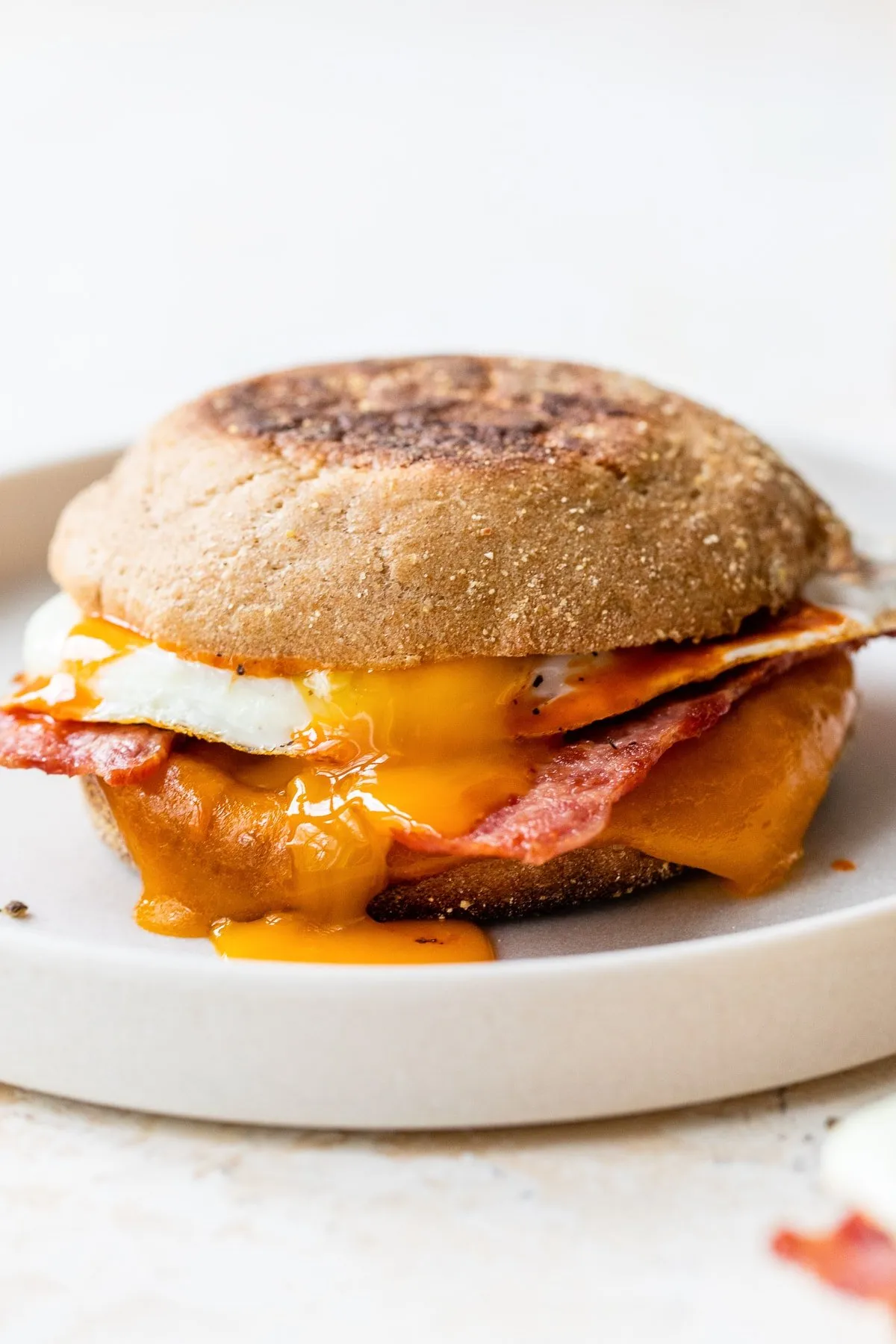 English Muffin Breakfast Sandwich with Bacon, Fried Egg, and Cheddar