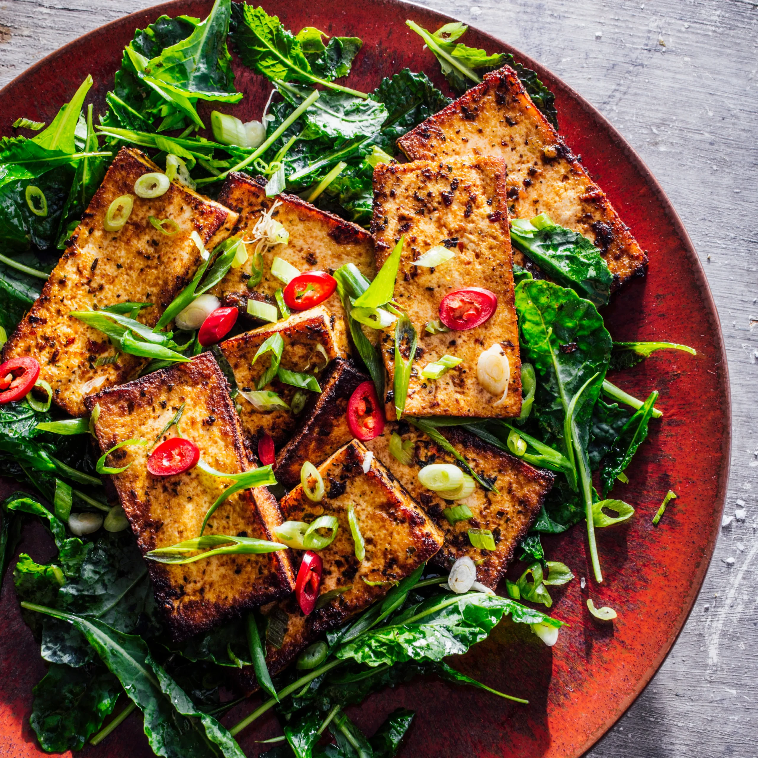 Pan Fried Ginger Tofu with Tahini over Kale