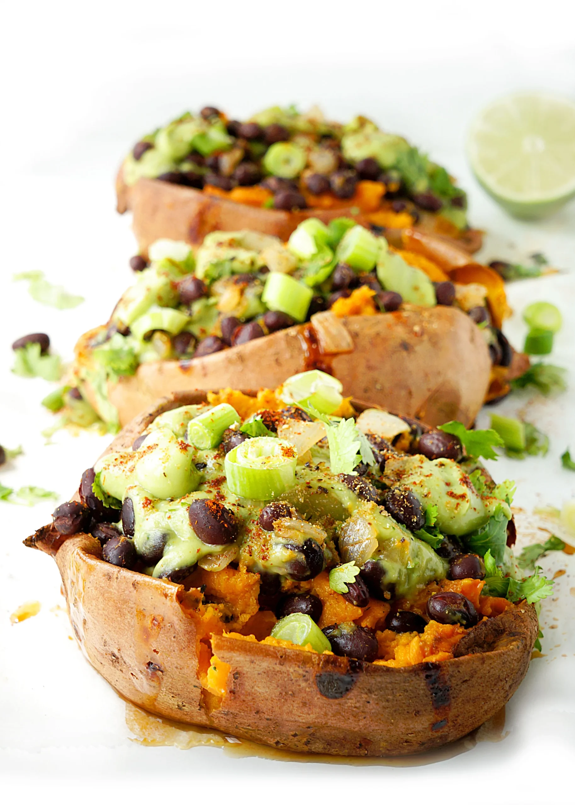 Spicy Black Bean Stuffed Sweet Potatoes with Creamy Avocado Sauce